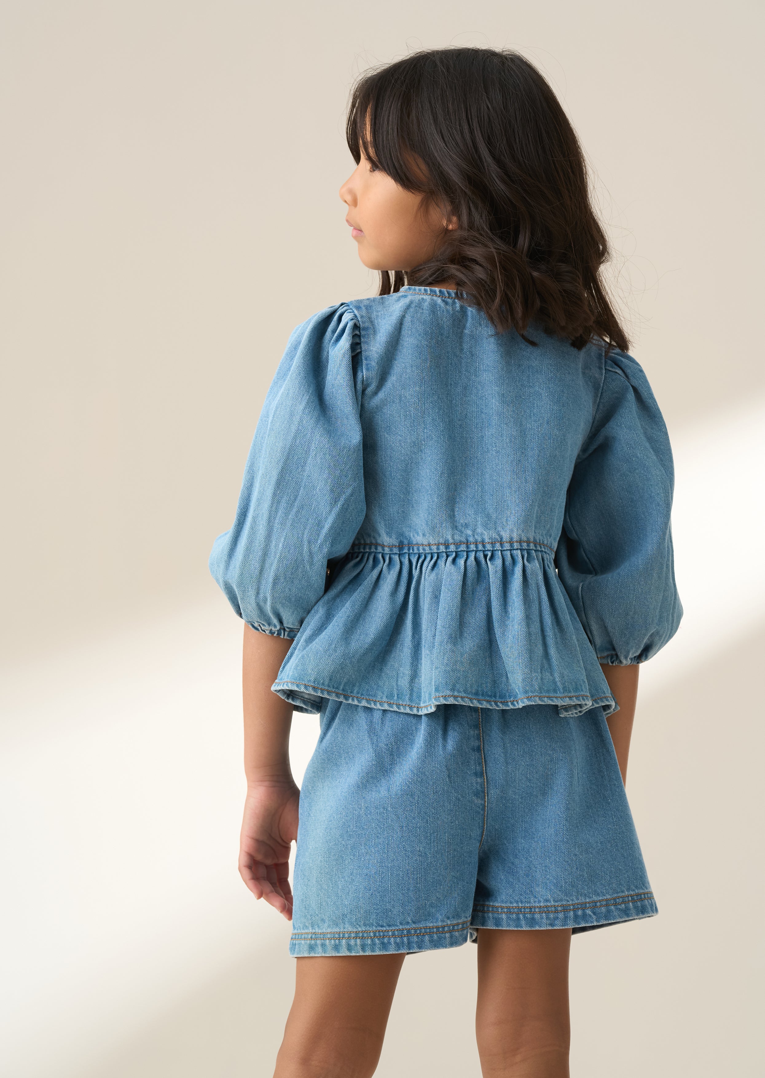 Rochelle Blue Denim Peplum Bow Top