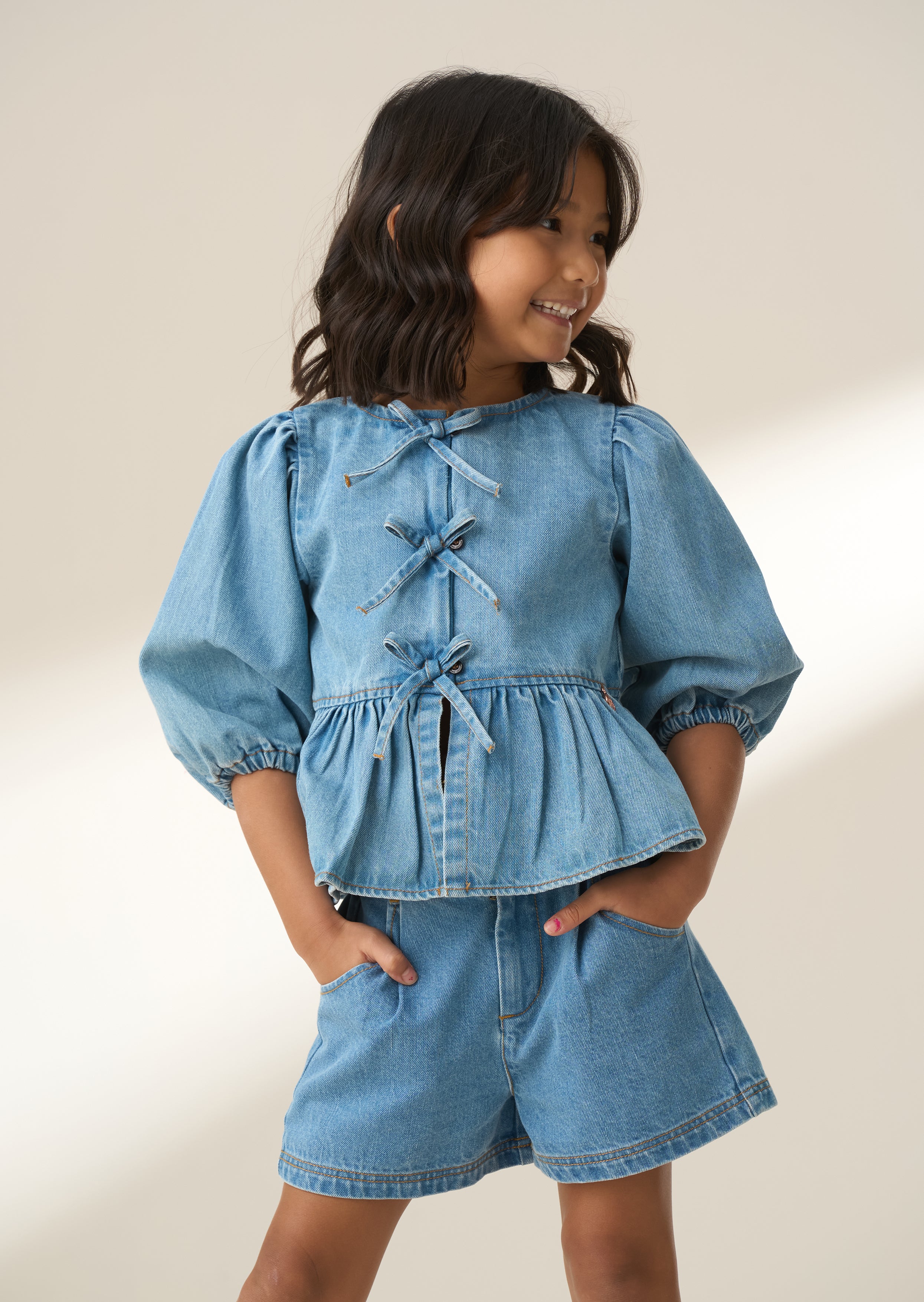 Rochelle Blue Denim Peplum Bow Top